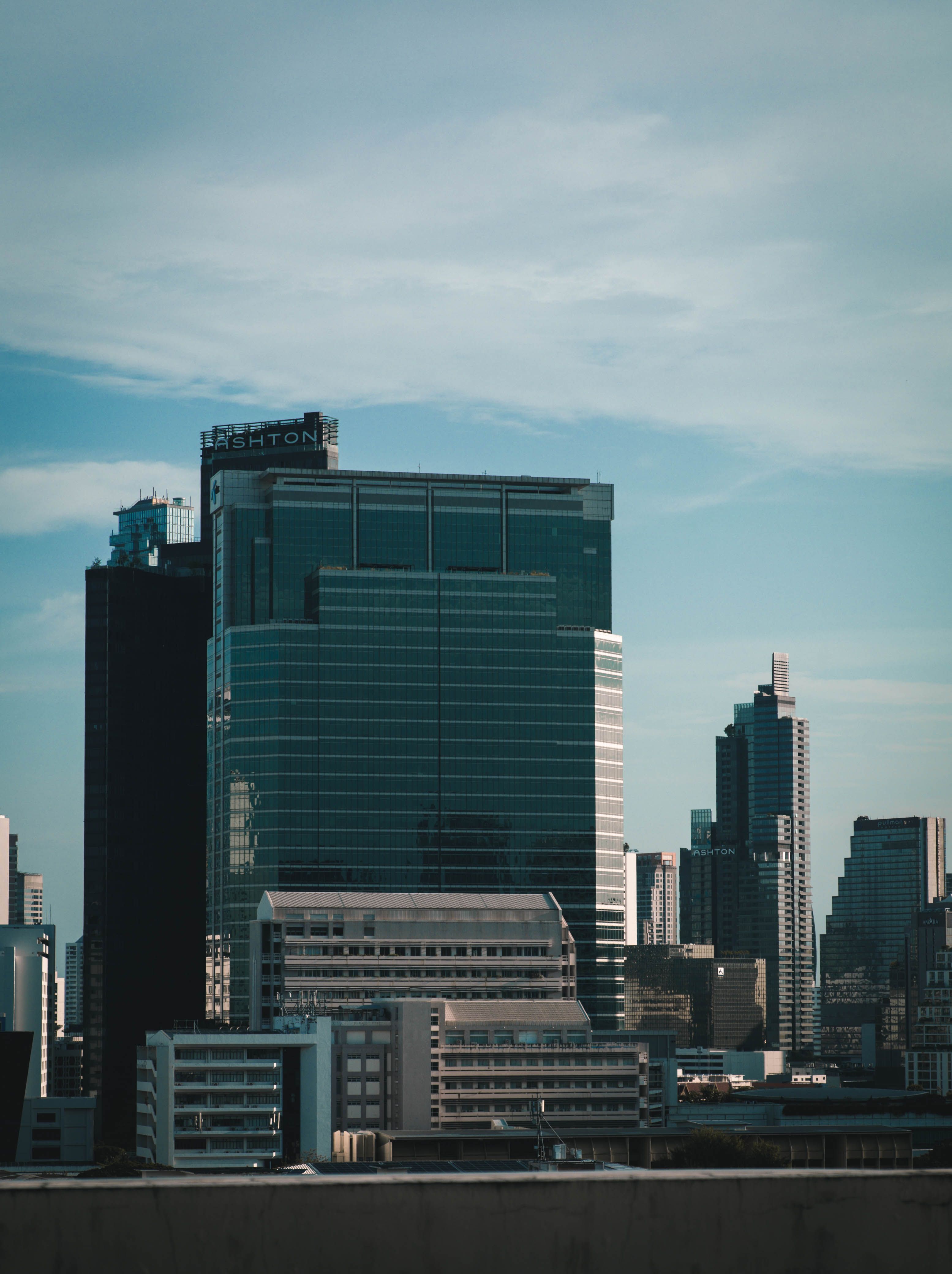 Modern skyscrapers in Bangkok under a clear blue sky, showcasing urban architecture.