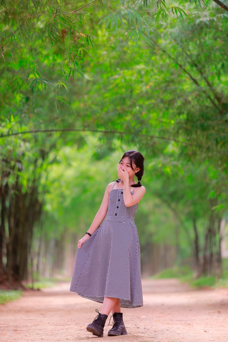 Girl In A Dress Posing In A Park