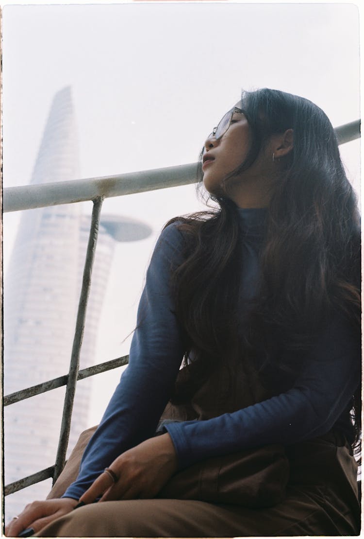 Cute Young Woman Sitting In The City