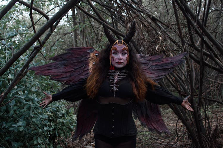 Woman In Costume With Wings And Horns