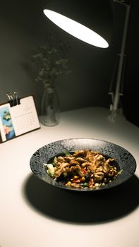 Elegant indoor dining scene with gourmet dish and moody lighting, perfect for cozy ambiance.