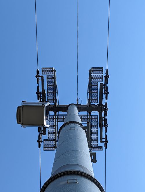 Free Upward view of a cable car pylon with wires stretching against a clear blue sky in Alanya, Türkiye. Stock Photo
