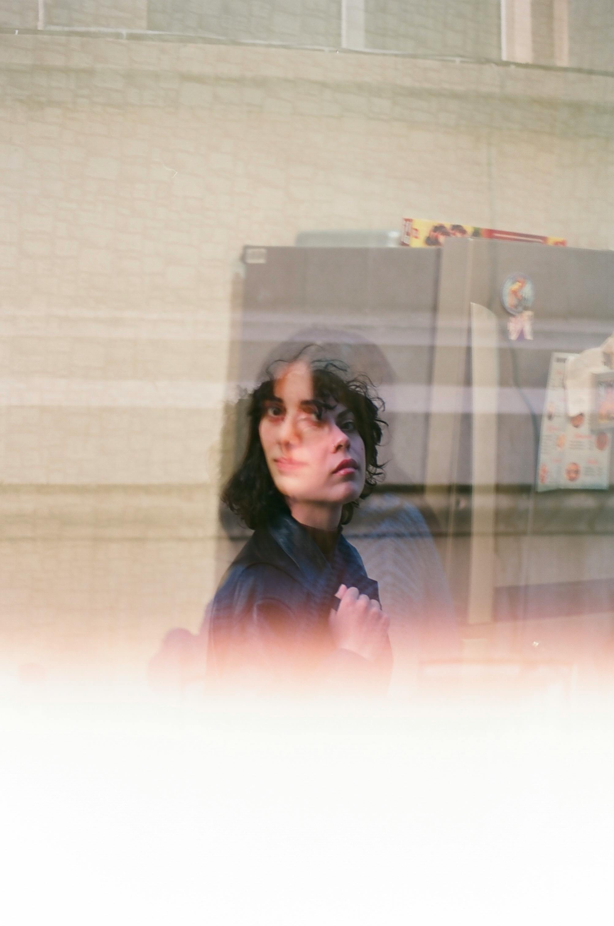 Intriguing double exposure photograph of a woman with artistic blur effect.