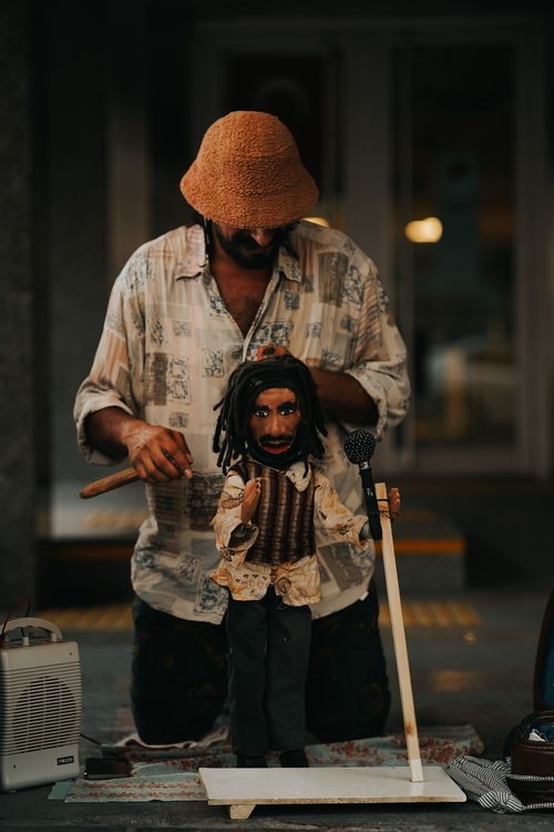 Free Street performer manipulating a puppet in Ankara, Türkiye, showcasing cultural expression. Stock Photo