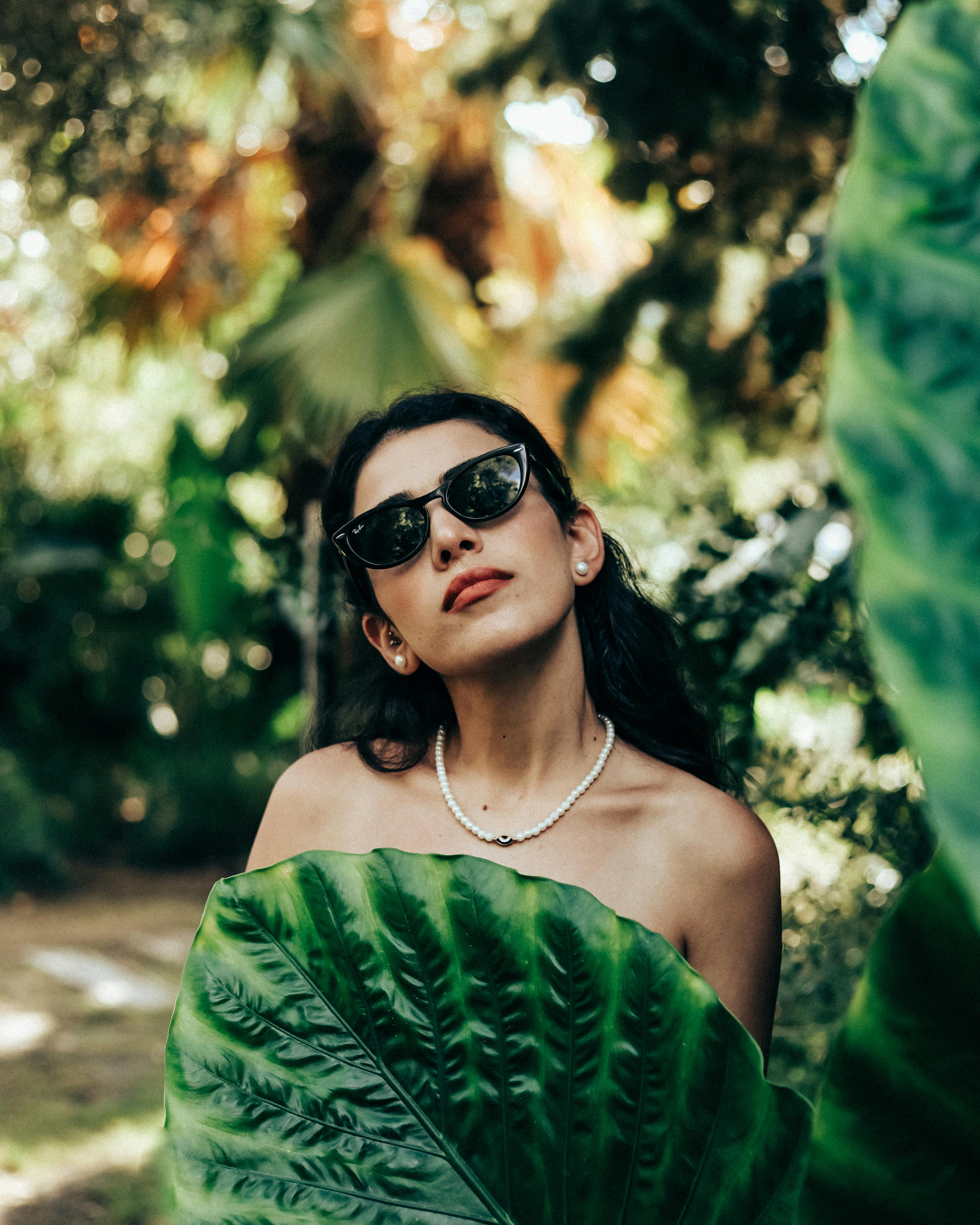 Portrait of Woman Among Tropical Plants · Free Stock Photo