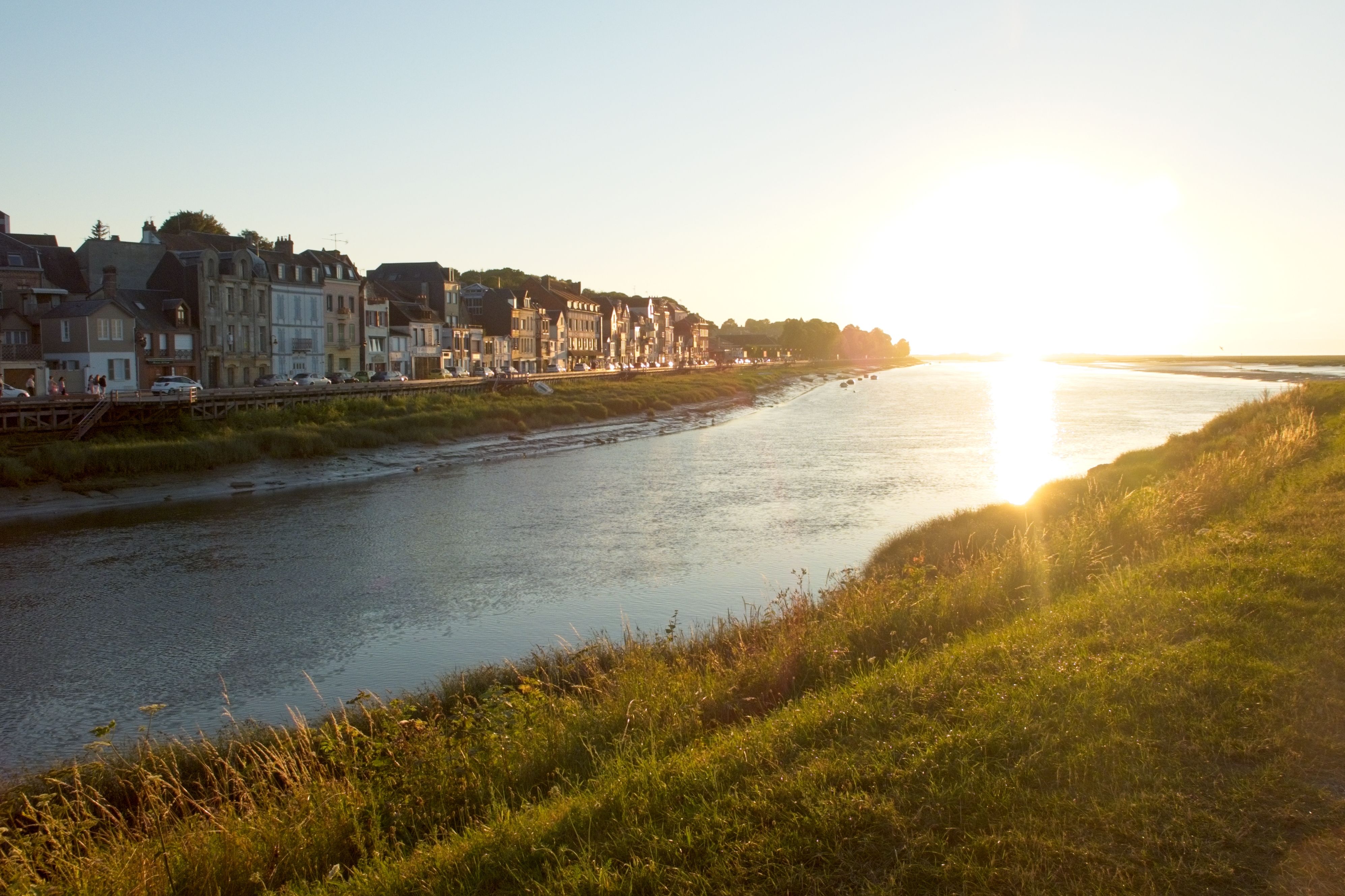 Urban Landscape with Sun Reflecting in a River · Free Stock Photo