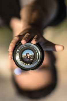 Inverted portrait of a man through a camera lens, creating a unique visual effect.