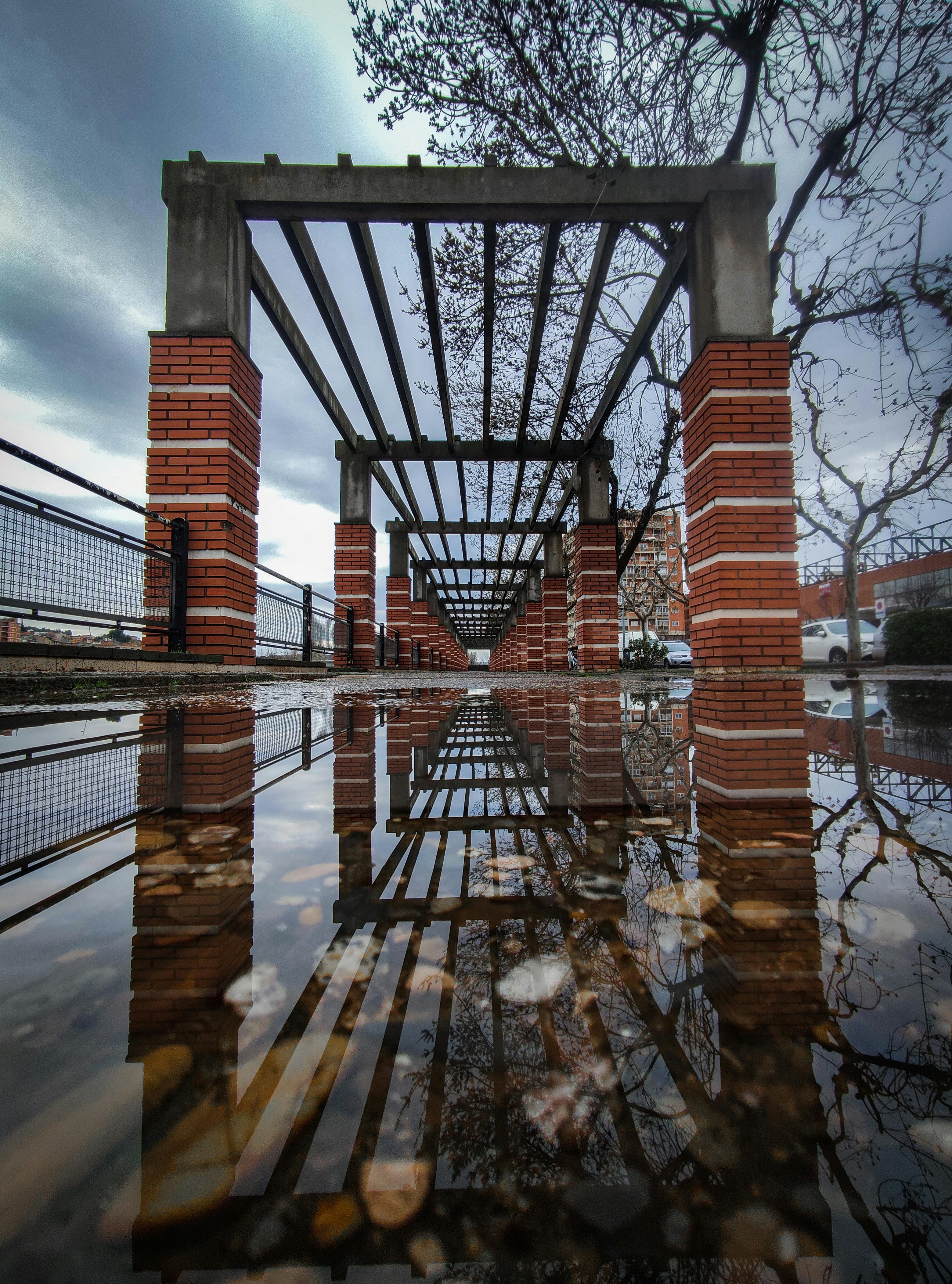Puddle on Ground on Brick Bridge in Autumn · Free Stock Photo