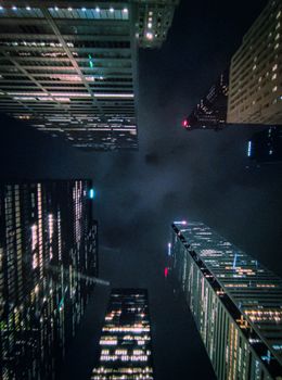 Stunning view of illuminated skyscrapers reaching into the night sky, city lights glowing.