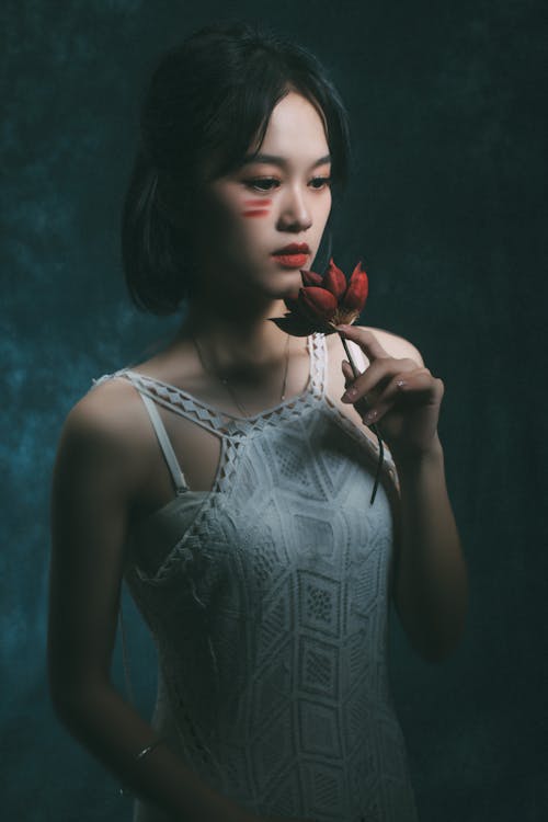 Free Portrait of a Woman Holding a Flower  Stock Photo