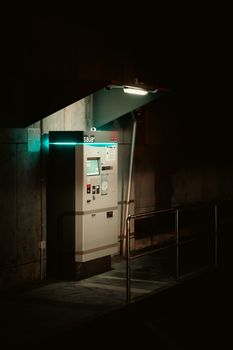 Moody urban night scene featuring a parking meter in Platja d'Aro, Spain.