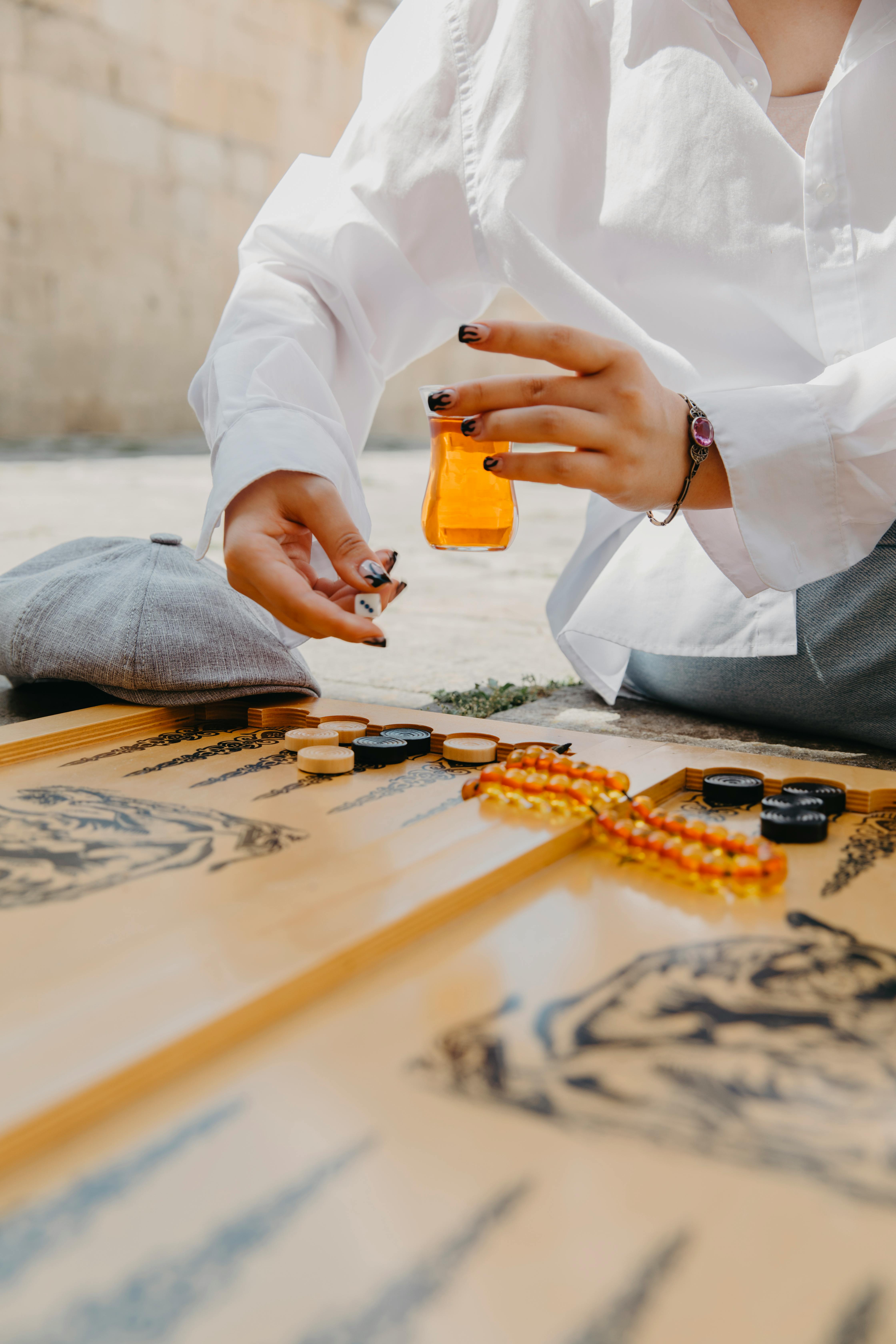 Close-up of a woman playing backgammon outdoors in Baku, Azerbaijan.