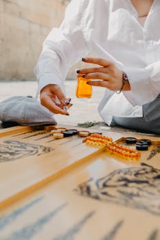 Close-up of a woman playing backgammon outdoors in Baku, Azerbaijan.