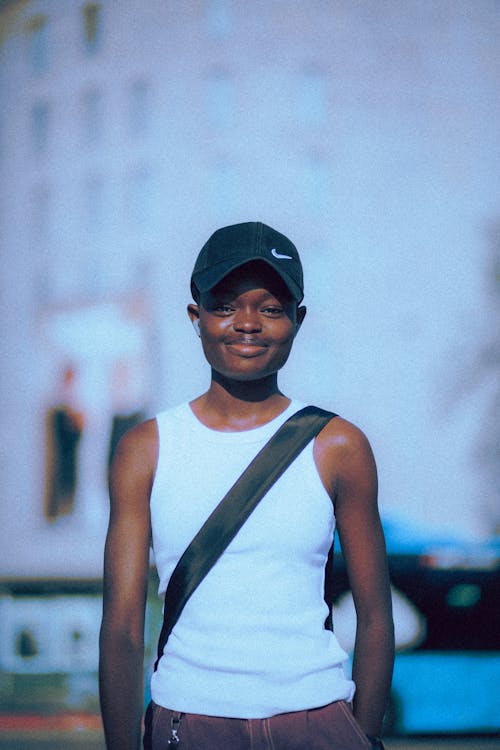 Smiling Girl in Baseball Hat on City Street