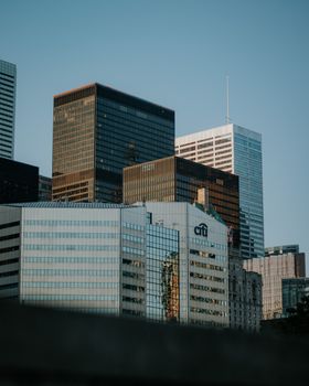 Stunning view of a modern cityscape featuring iconic skyscrapers against a clear bluish sky.