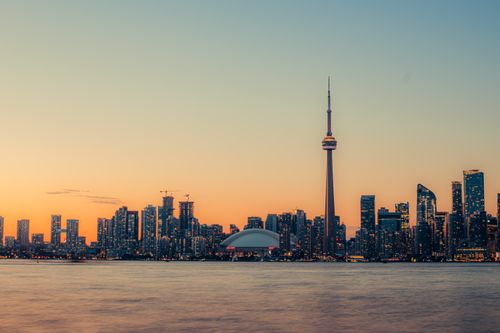 Free Stunning view of Toronto's skyline at sunset, highlighting the CN Tower and Lake Ontario waterfront. Stock Photo