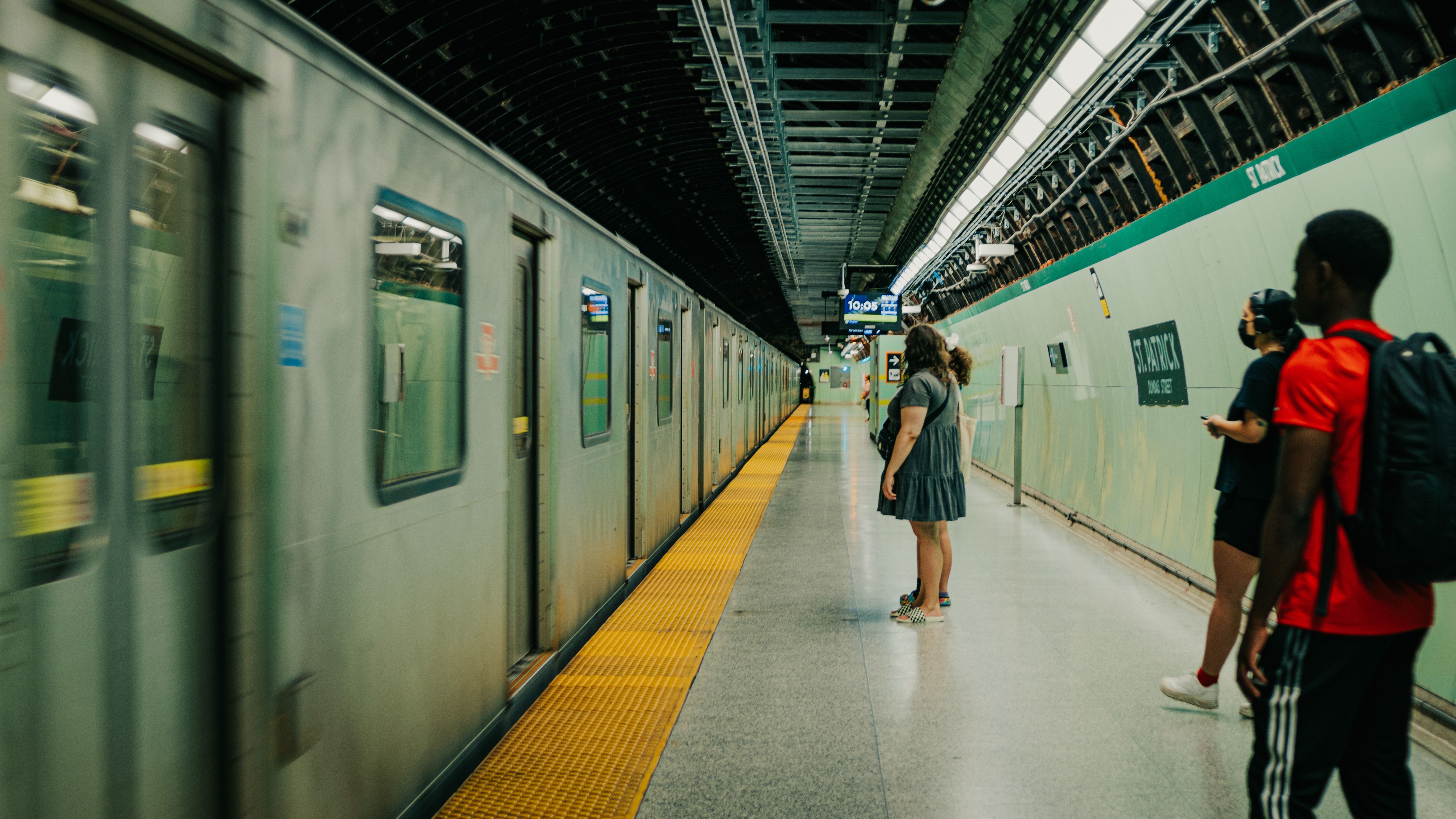 A modern Sofia metro train arriving at Serdika station with passengers waiting on the platform