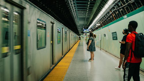 People Standing on Platform near Train in Subway