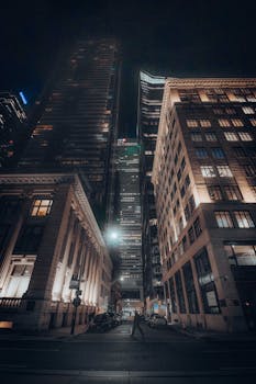 A captivating view of illuminated skyscrapers in a downtown city at night.