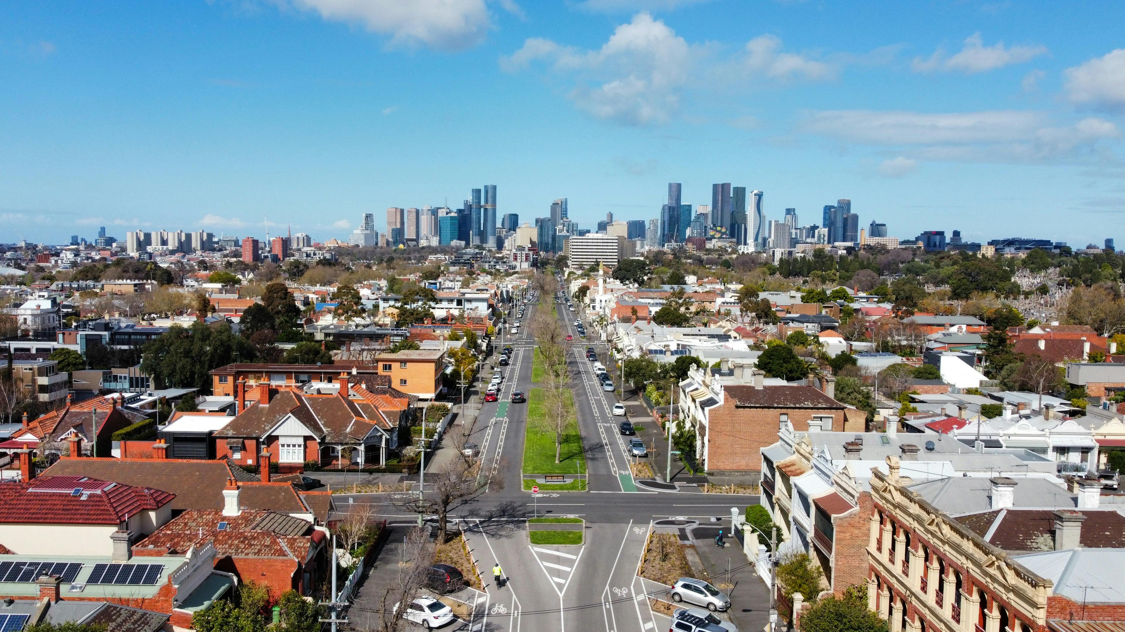 A view of an urban street, leading into a sprawling city.