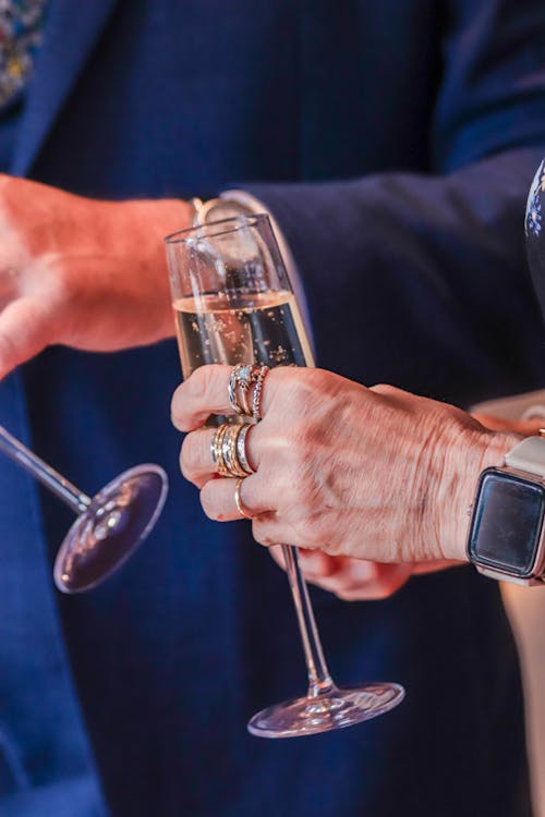 Close-up of People Holding Glasses with Champagne