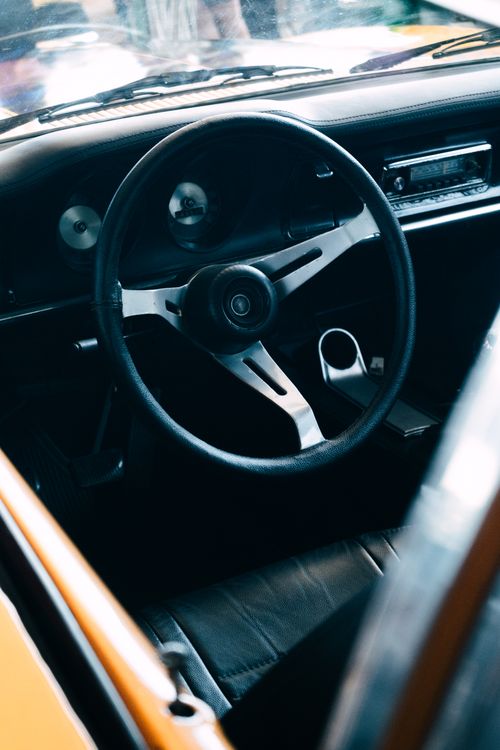 Free Explore the vintage charm of a classic Chevrolet Opala car interior featuring a timeless steering wheel and dashboard. Stock Photo