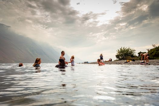 A serene family scene at Wasdale Head Lake, England. Perfect for reflecting leisure activities.