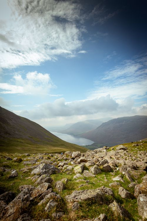 Free Scenic view of rocky hills overlooking a lake and distant mountains at Wasdale Head, UK. Stock Photo