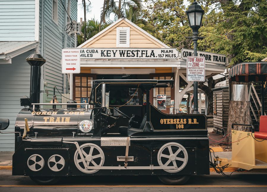 Scenic view of Conch Tour Train parked in Key West, Florida, capturing a vintage travel charm.