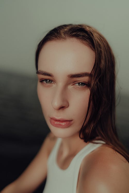 A woman with long hair and a white top