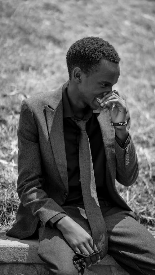African Man Wearing Suit on a Meadow in Black and White 