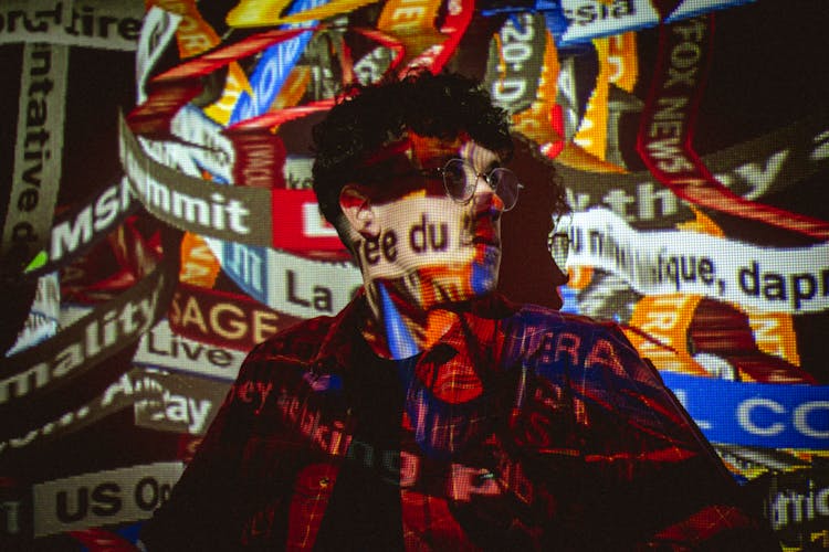 Multi Colored Labels Screening On Standing Man In Eyeglasses