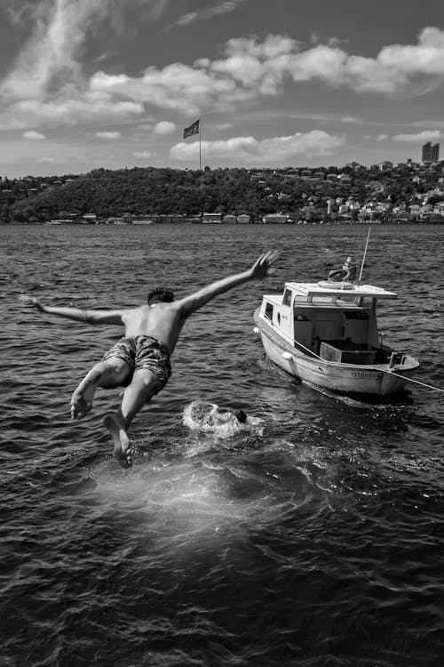 A Man Jumping into the Water from a Boat 