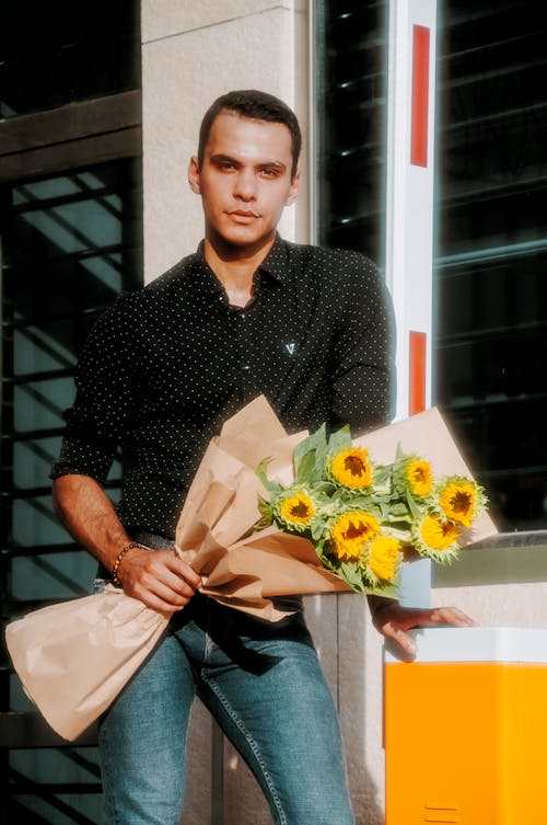 Man Holding a Bouquet of Sunflowers 