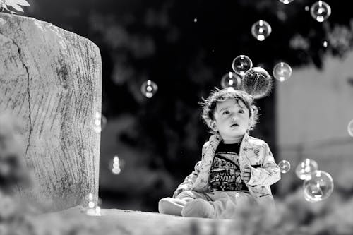 Child Looking at Soap Bubbles