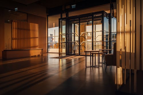 Light of the Setting Sun Streaming into the Lobby through the Glass Double Doors