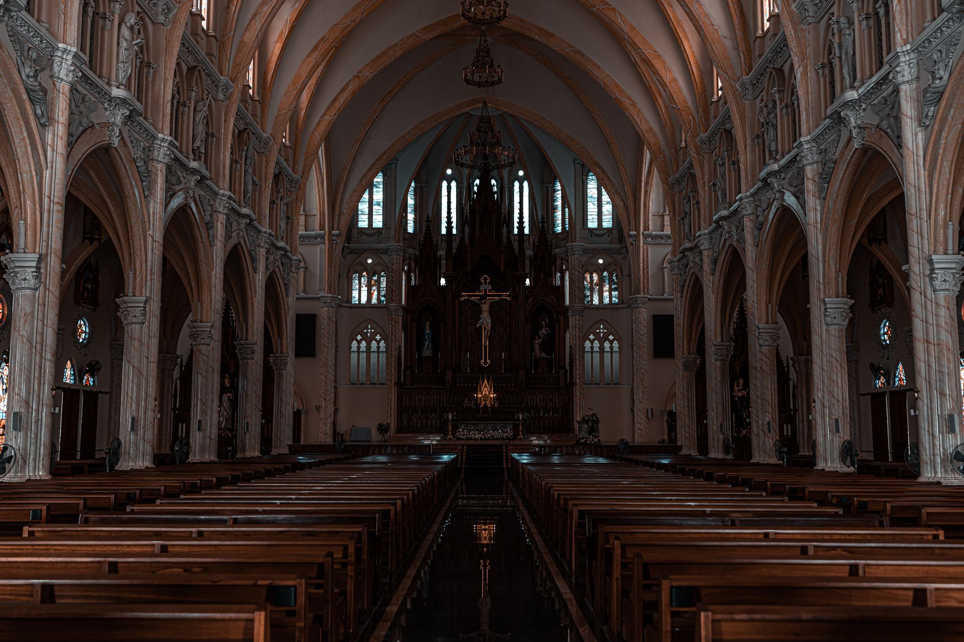 Beautiful view of a Gothic cathedral's interior with detailed arches and altar.