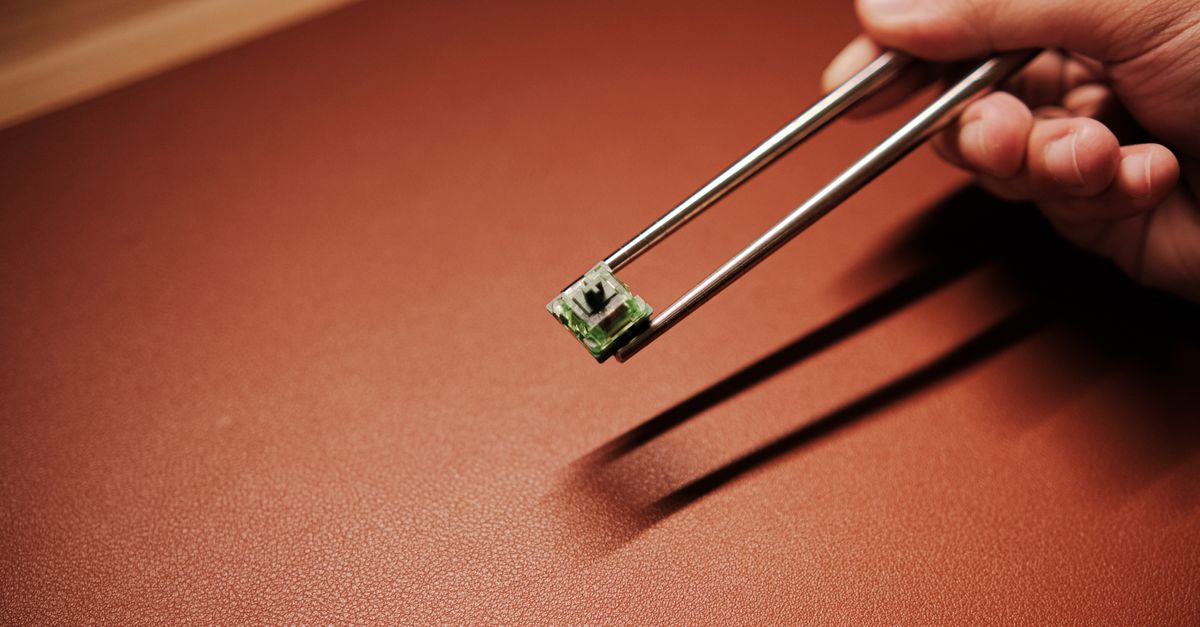 Man Holding Mechanical Switch by Chopsticks · Free Stock Photo