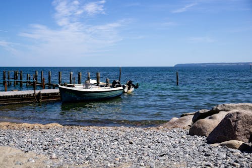 A Boat Moored to the Pier on the Shore