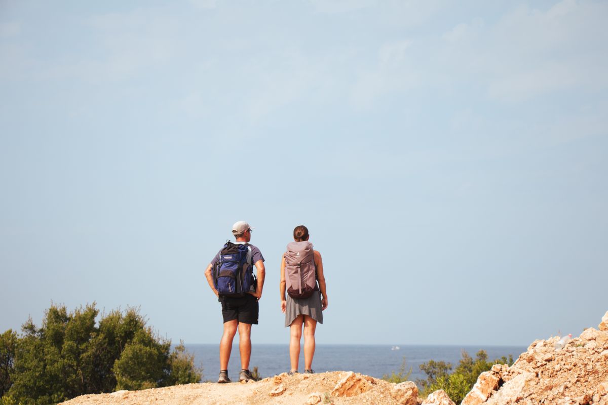 Travelers exploring a dramatic coastline