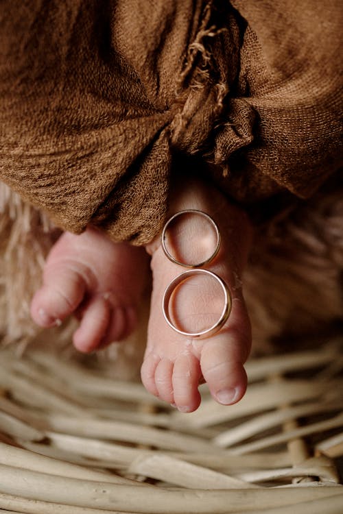 Wedding Rings Lying on Babys Foot