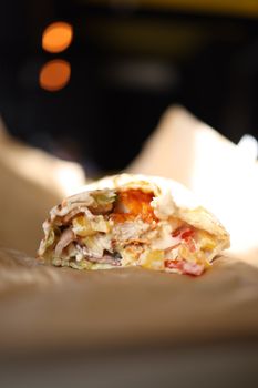Close-up of a fresh doner kebab with vegetables, showcasing vibrant colors and textures.