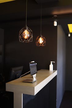Stylish café interior featuring geometric pendant lights and a sleek counter design.