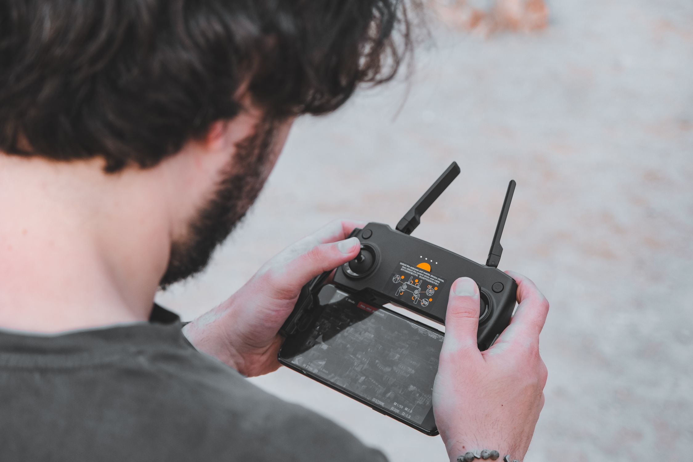 Man Holding a Remote Control Pilot · Free Stock Photo
