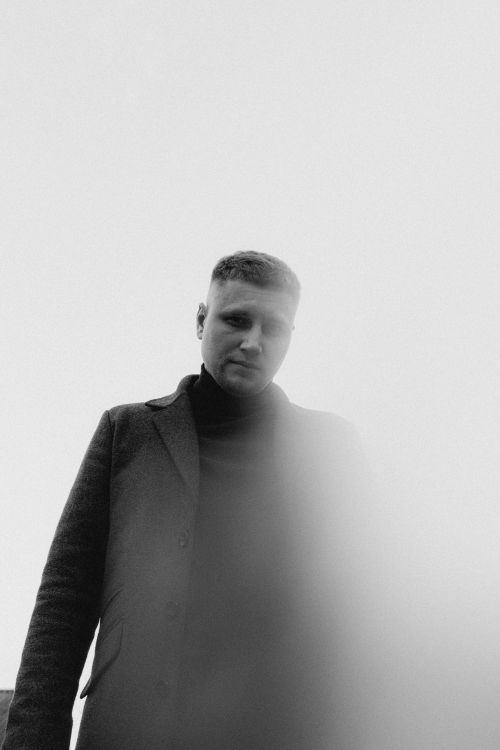 Free Artistic monochrome portrait of a man wearing a coat, photographed in Vitebsk, Belarus. Stock Photo