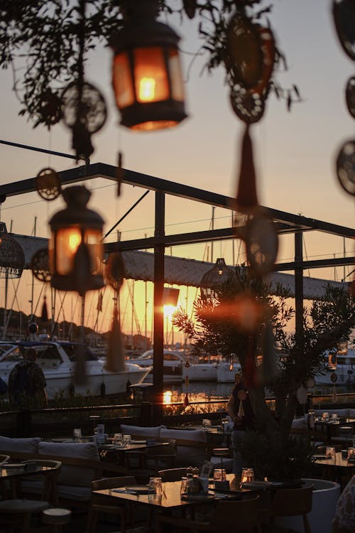 A restaurant with lanterns hanging from the ceiling