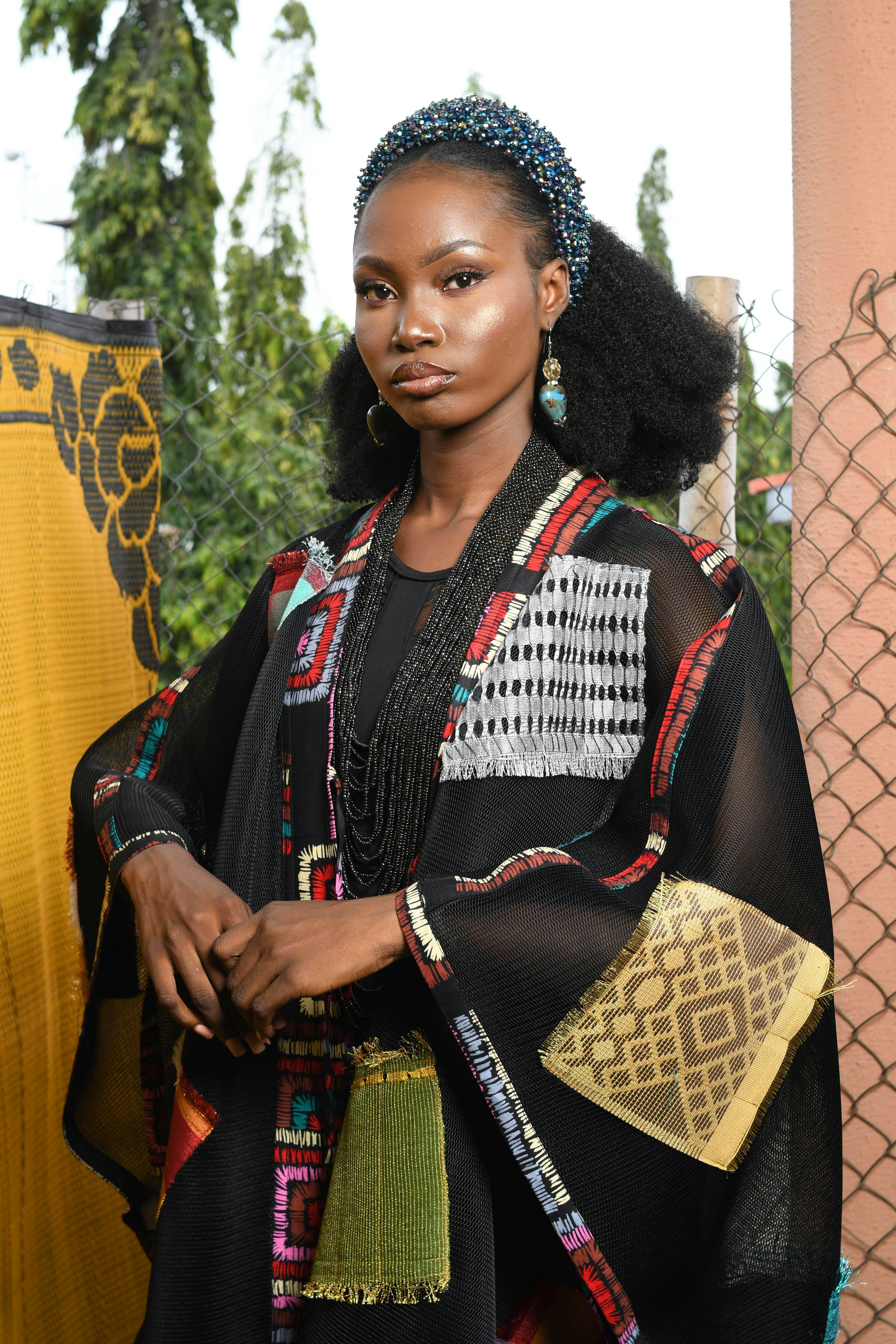 Portrait of a woman in traditional African attire, showcasing vibrant style and elegance.