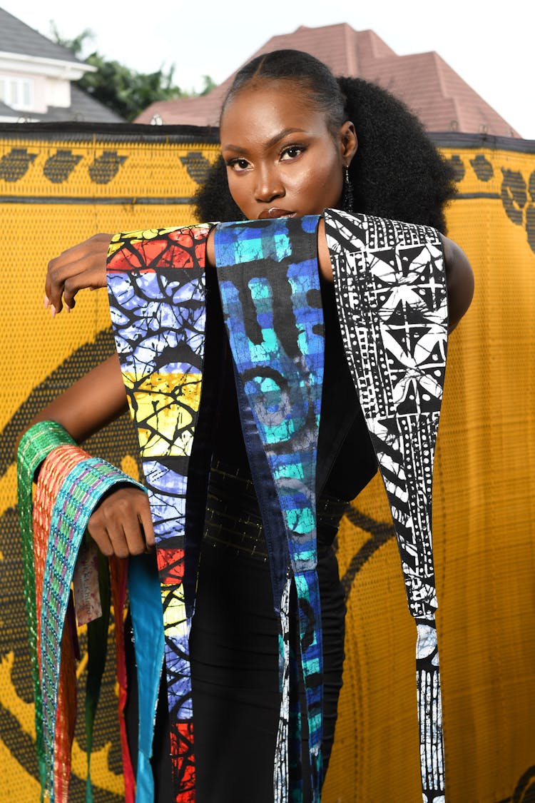 Young Woman Holding Fabric With Colorful Patterns