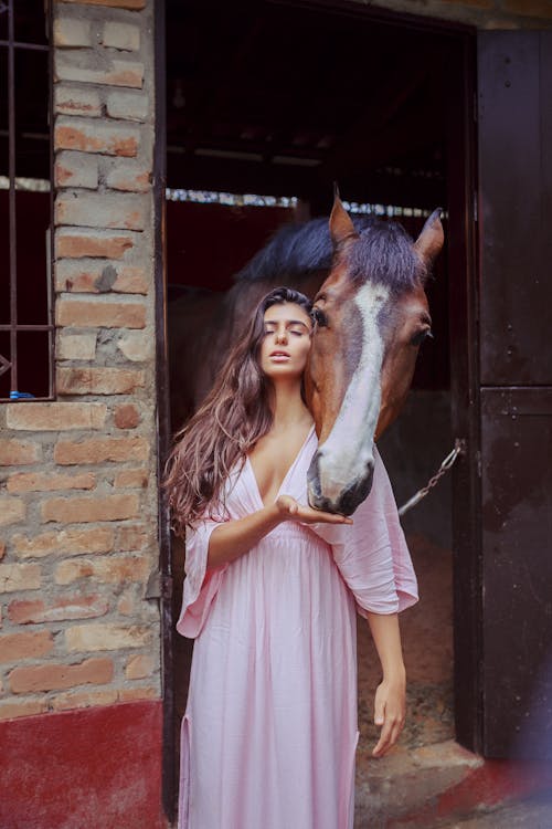 Woman Standing In Front Of Horse