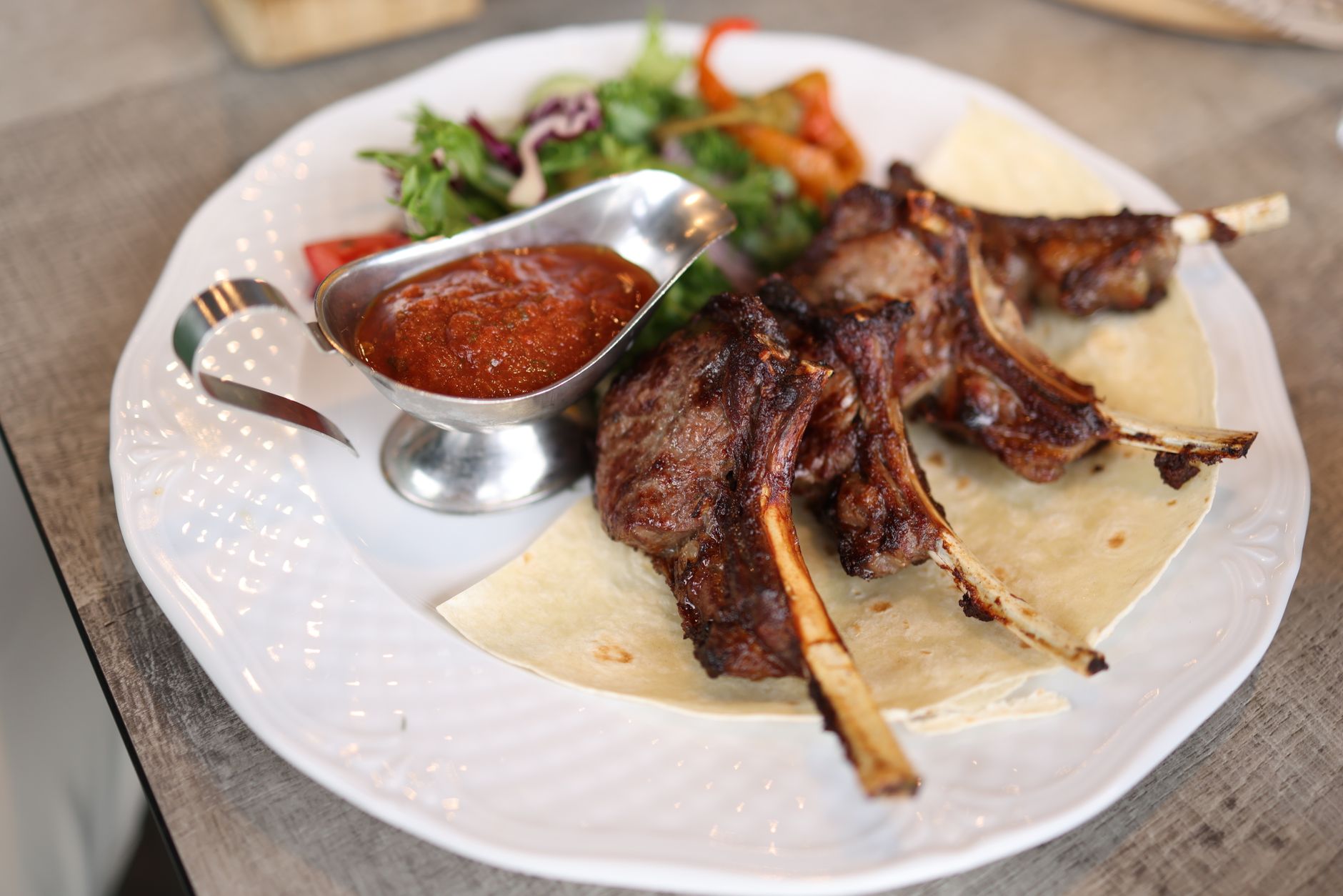 Traditional Bulgarian meal of shopska salad, grilled meats and wine